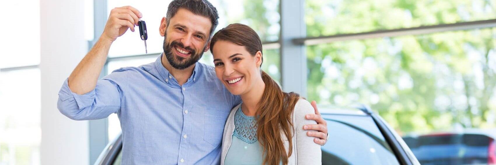 Couple Posing with New Vehicle Keys