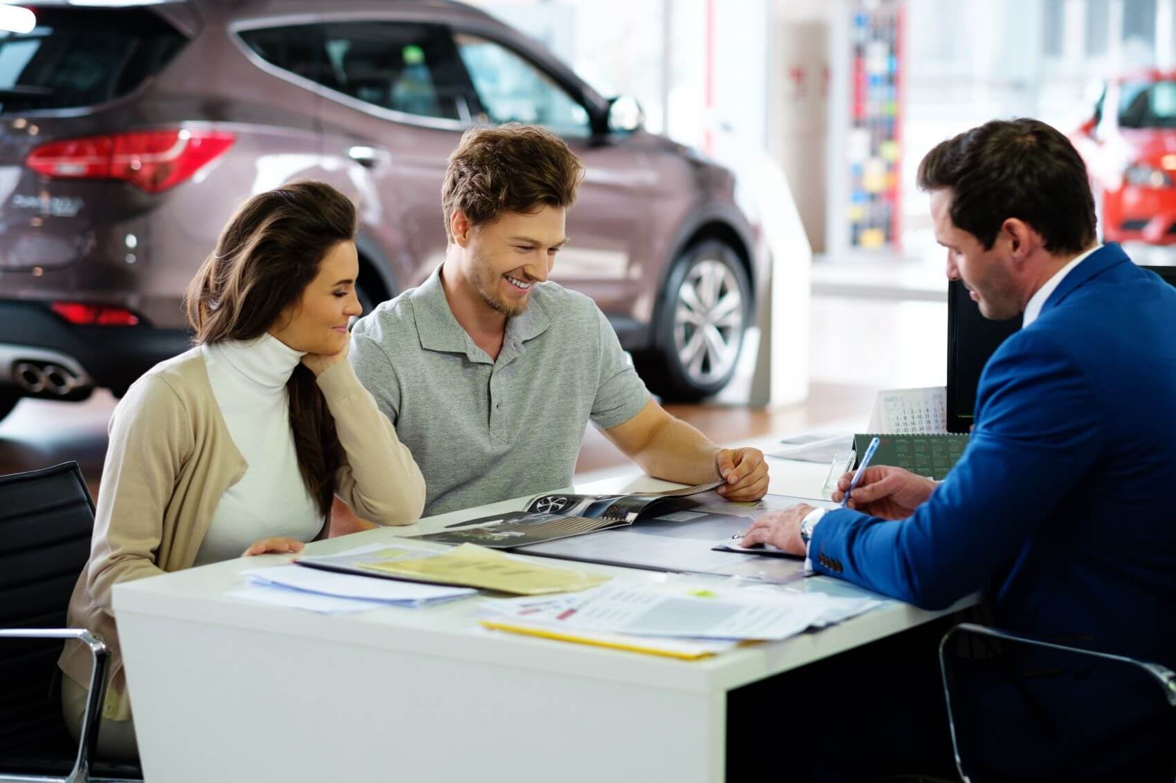 Customers Sitting at Desk with Dealer